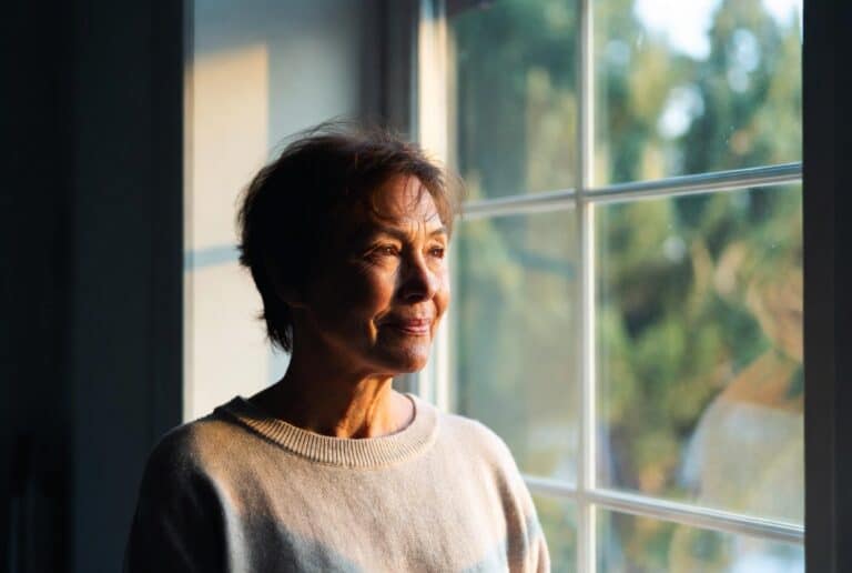 grief and loss calm adult reflecting by window
